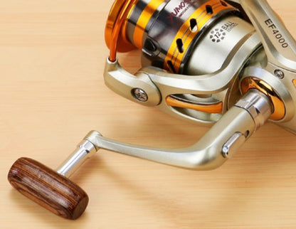 Carrete de pesca YUMOSHI 12BB ultraligero con mango de madera y cuerpo metálico