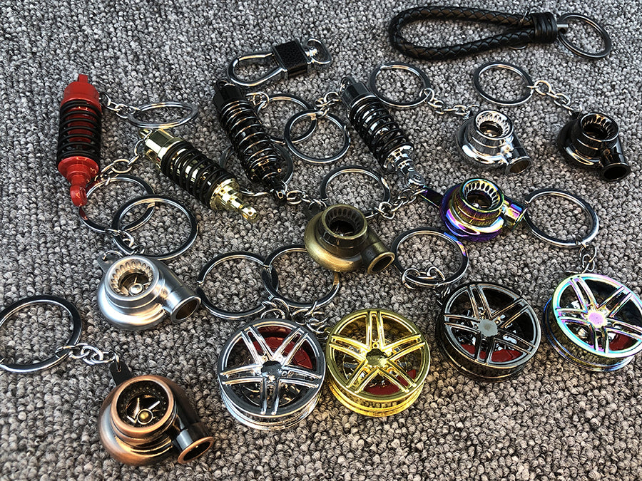 Llavero turbo deportivo con rueda y amortiguador – Accesorio metálico con cuerda trenzada y caja de regalo