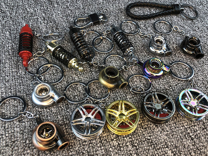 Llavero turbo deportivo con rueda y amortiguador – Accesorio metálico con cuerda trenzada y caja de regalo