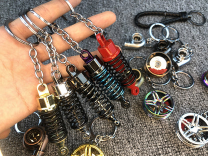 Llavero turbo deportivo con rueda y amortiguador – Accesorio metálico con cuerda trenzada y caja de regalo