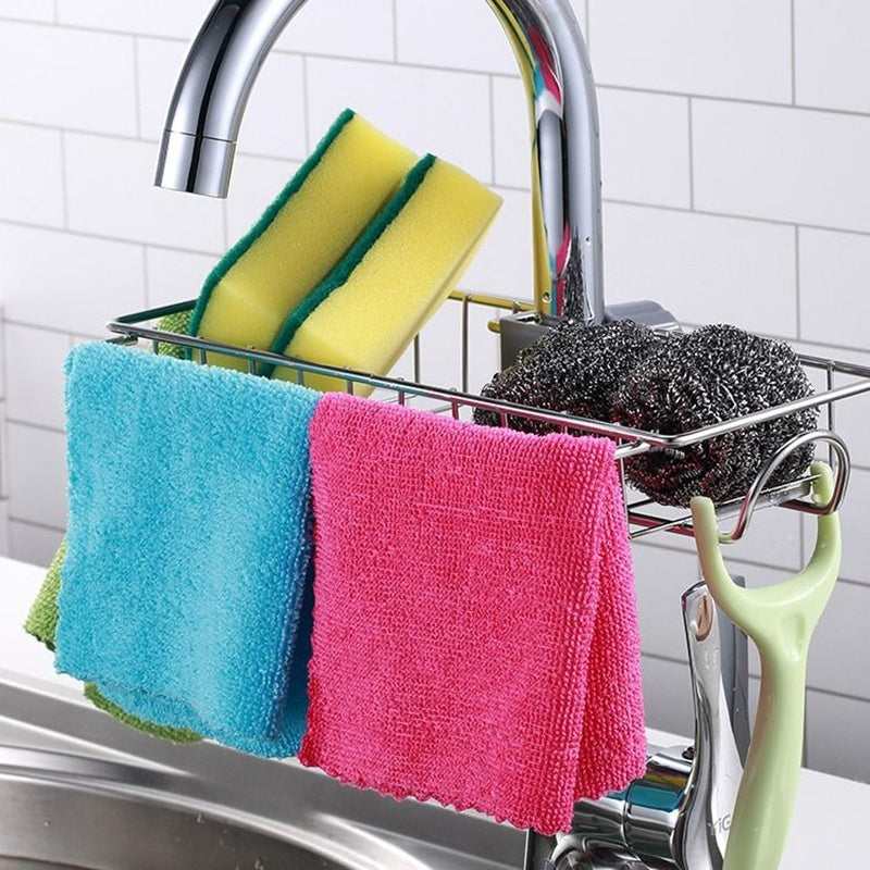 Organizador ajustable de fregadero en acero inoxidable y ABS para utensilios, esponjas y jabones.