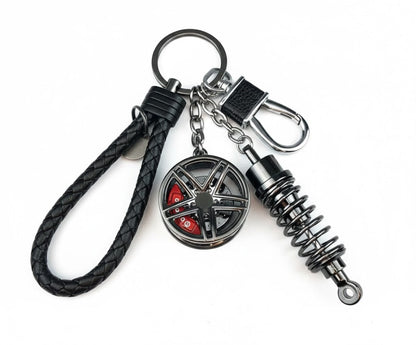 Llavero turbo deportivo con rueda y amortiguador – Accesorio metálico con cuerda trenzada y caja de regalo