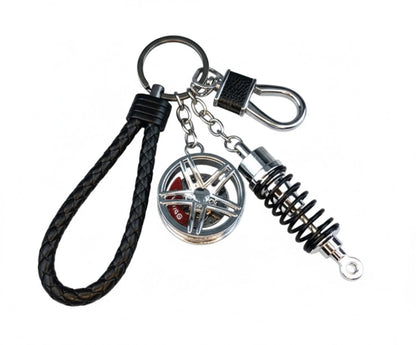 Llavero turbo deportivo con rueda y amortiguador – Accesorio metálico con cuerda trenzada y caja de regalo